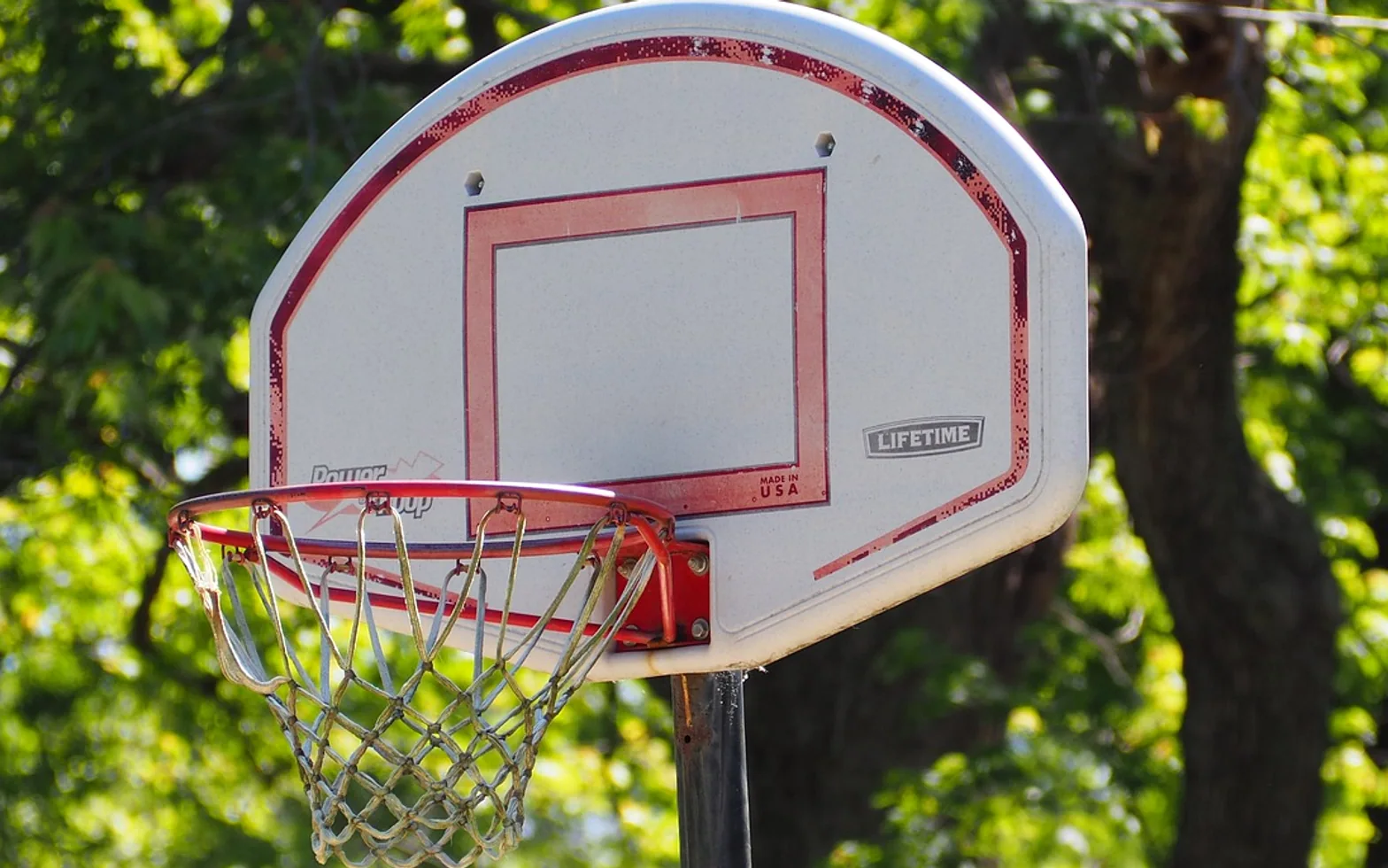 Basketball, basketball hoop and rusted basketball hoop